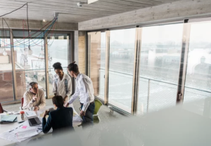 professionals reviewing a tender on an iPad in a modern office, illustrating how website credibility influences contract success.